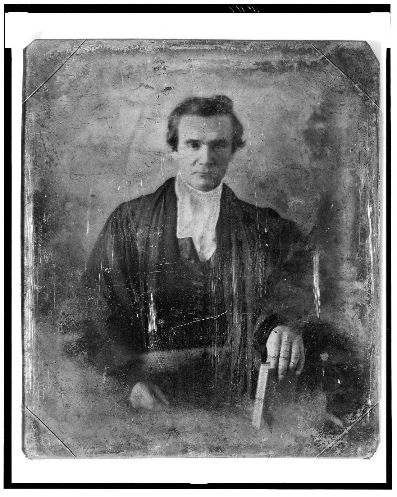 [Rev. Henry Anthon, half-length portrait, facing front, wearing robe, holding book], [between 1844 and 1860] — historic photograph
