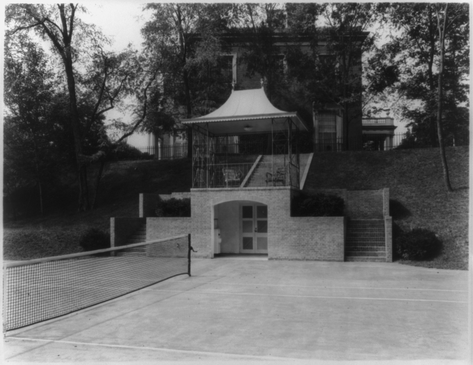 [Agnes Meyer's home, 1624 Crescent Pl., Washington, D.C., looking toward house from tennis courts], [between 1934 and 1950] — historic photograph