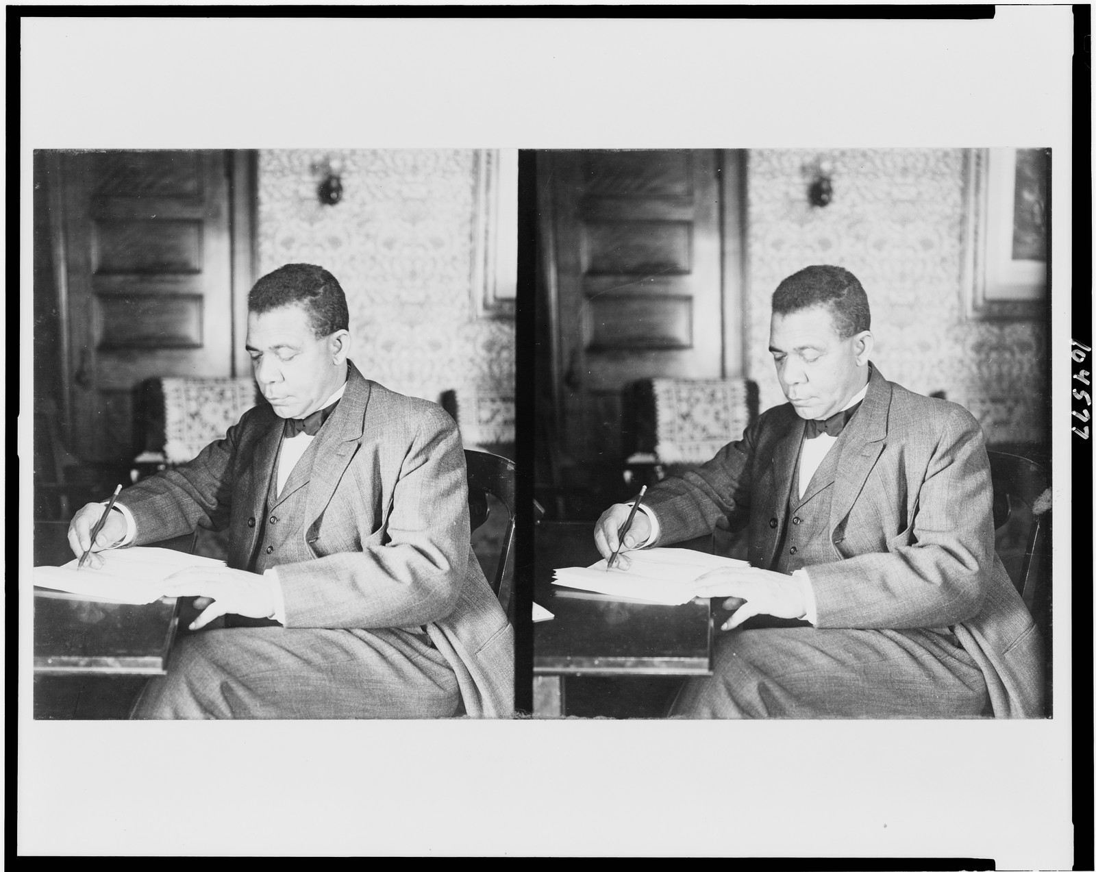 [Booker T. Washington, three-quarter length portrait, seated, facing left, writing], c1906. — historic photograph