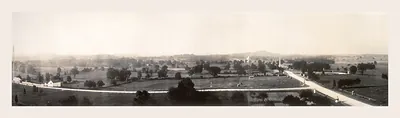 Panoramic sepia view of rolling farmland and a road