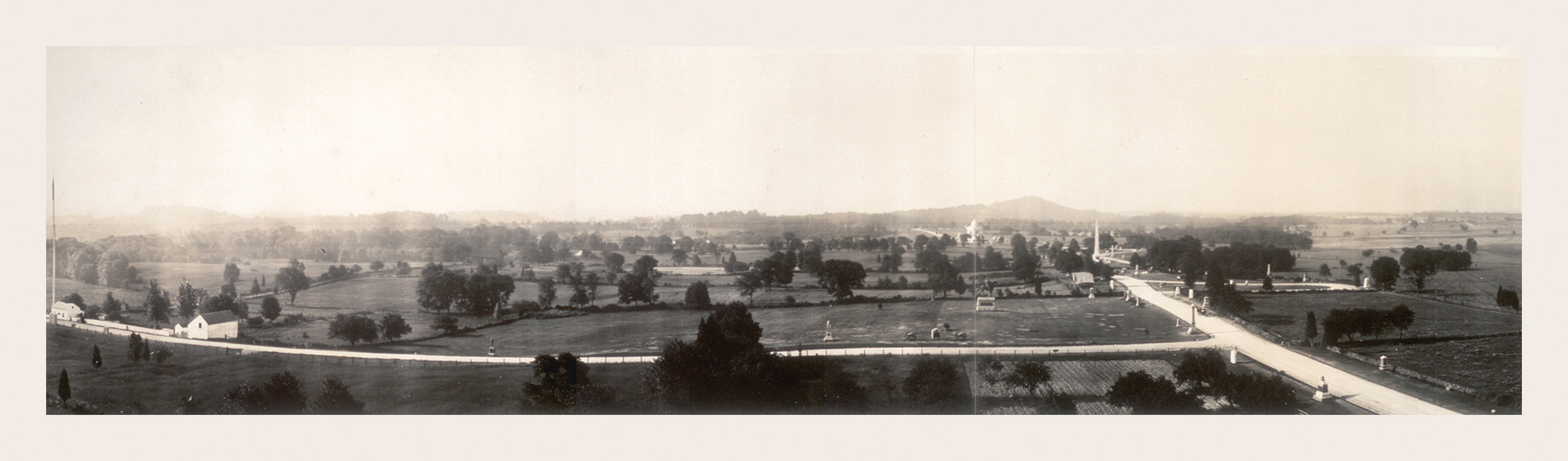 Panoramic sepia view of rolling farmland and a road, 1918 — historic image