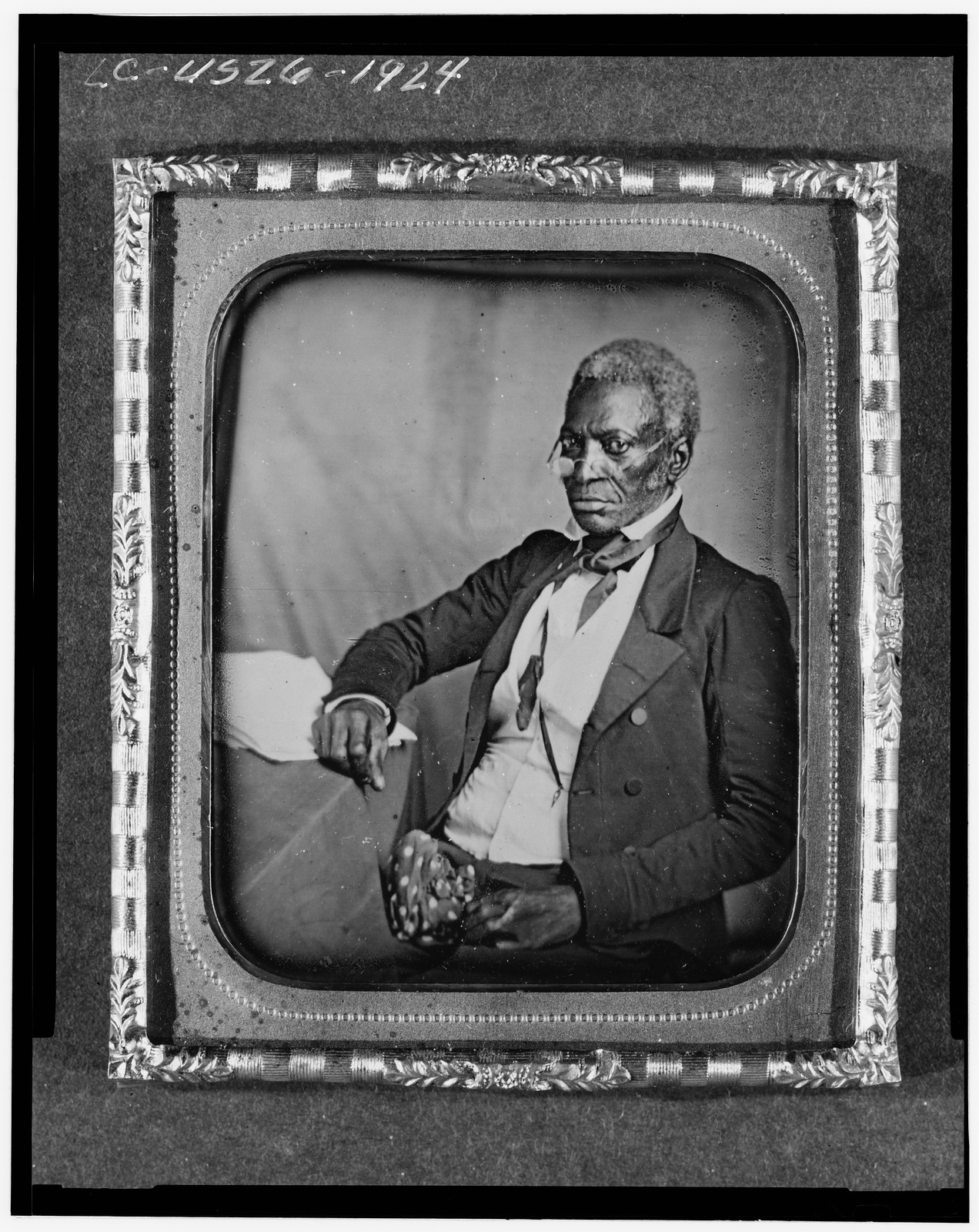 [John Hanson, three-quarter length portrait, three-quarters view, wearing glasses, seated at desk], [between 1856 and 1860] — historic photograph