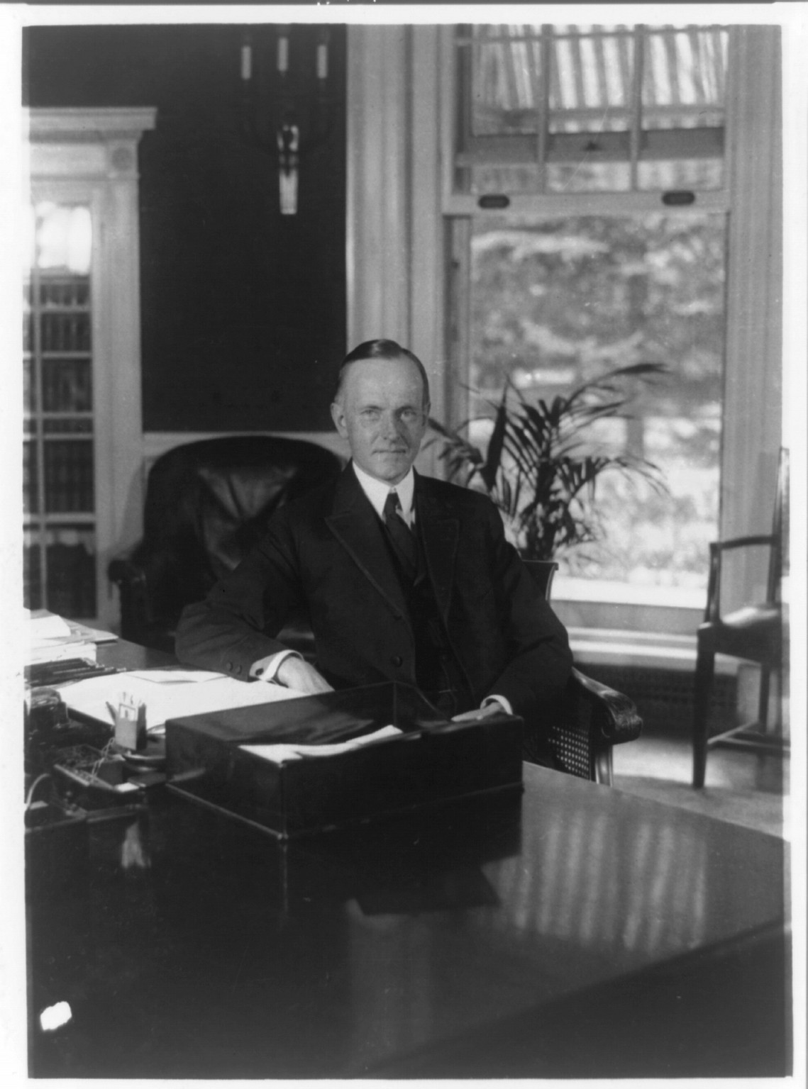 [Calvin Coolidge, half-length portrait, seated at desk in Oval Office, facing front], 1923 Aug. 15. — historic photograph