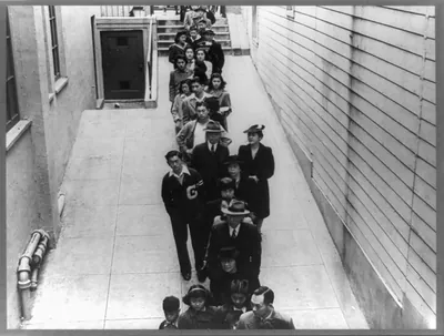 Residents of Japanese ancestry waiting in line for voluntary inoculation against typhoid, preceding evacuation and housing in War Relocation Authority centers for the duration, San Francisco, Calif.