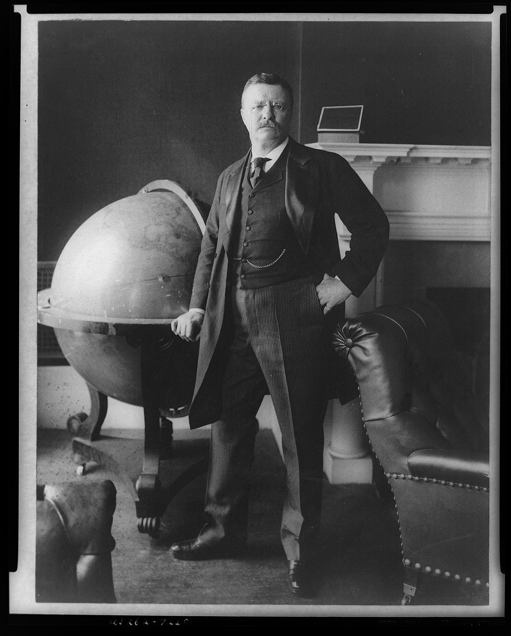 [Theodore Roosevelt, full-length portrait, standing beside large globe, facing front], c1903 Feb. 24. — historic photograph