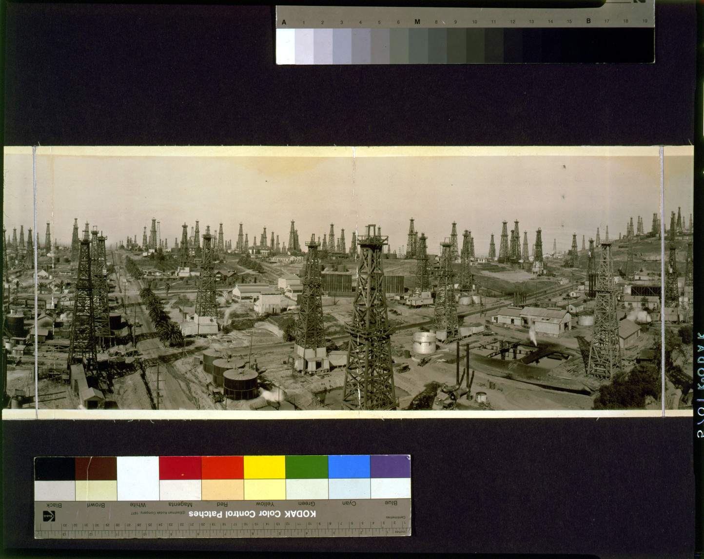 Panoramic photograph of oil derricks across an oil field — historic photograph