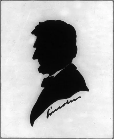 Black silhouette profile of a man with cursive signature