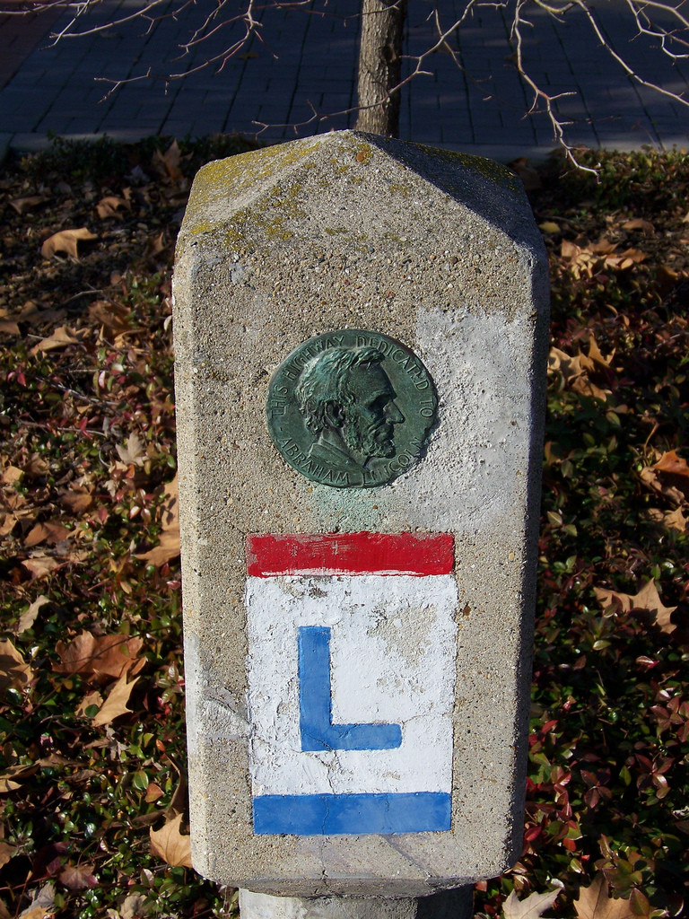 Lincoln Highway concrete marker with bronze Abraham Lincoln medallion — historic image