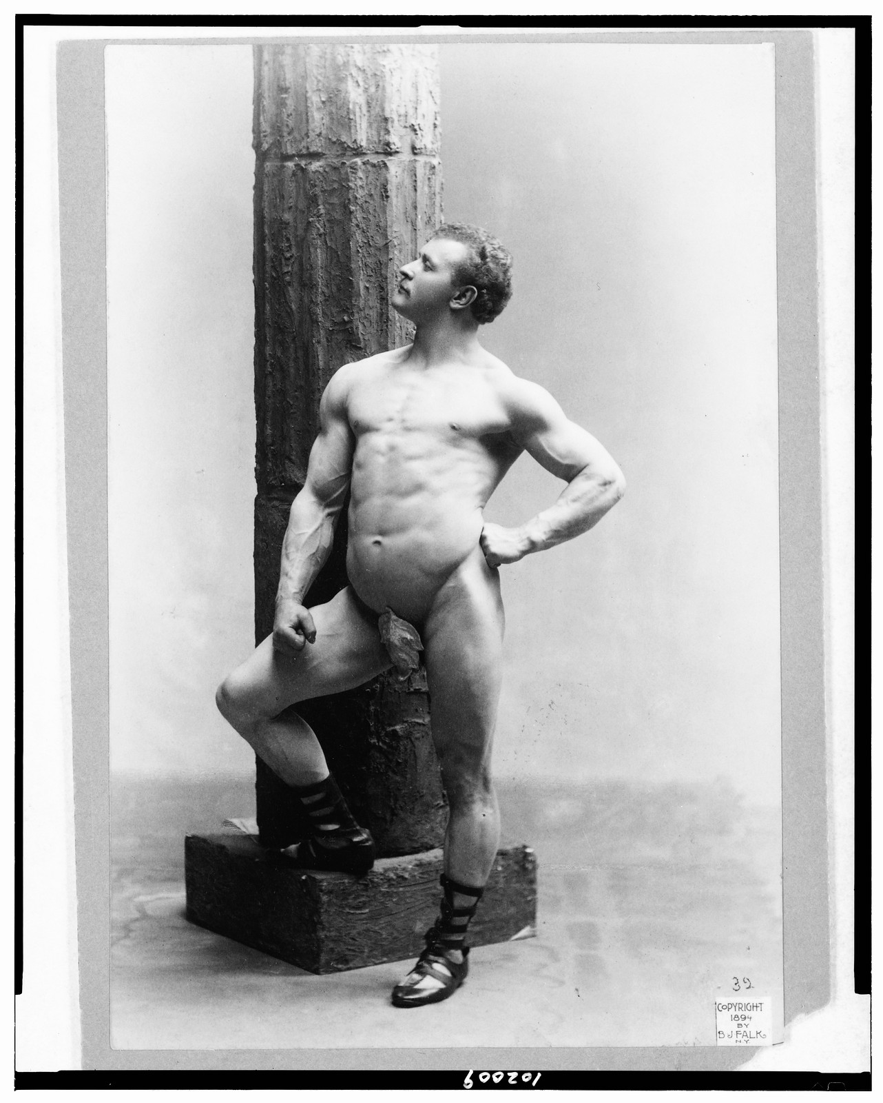 [Eugen Sandow, full-length nude portrait, standing by column, facing left], c1894. — historic photograph