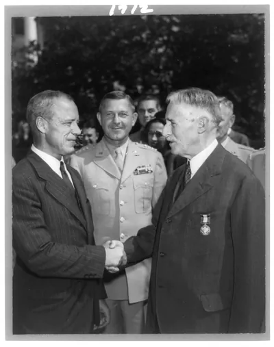 [Ceremony on White House lawn in which former Secretary of War Henry L. Stimson received the Distinguished Service Medal. Left to right: Secretary of War Robert P. Patterson, Gen. Jacob L. Devers, and Henry L. Stimson]