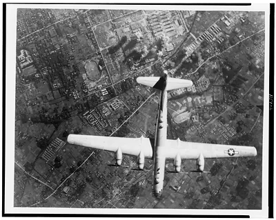 [Aerial view of American bomber dropping bombs on Nakajima Aircraft Co., Musashino Plant, Japan]