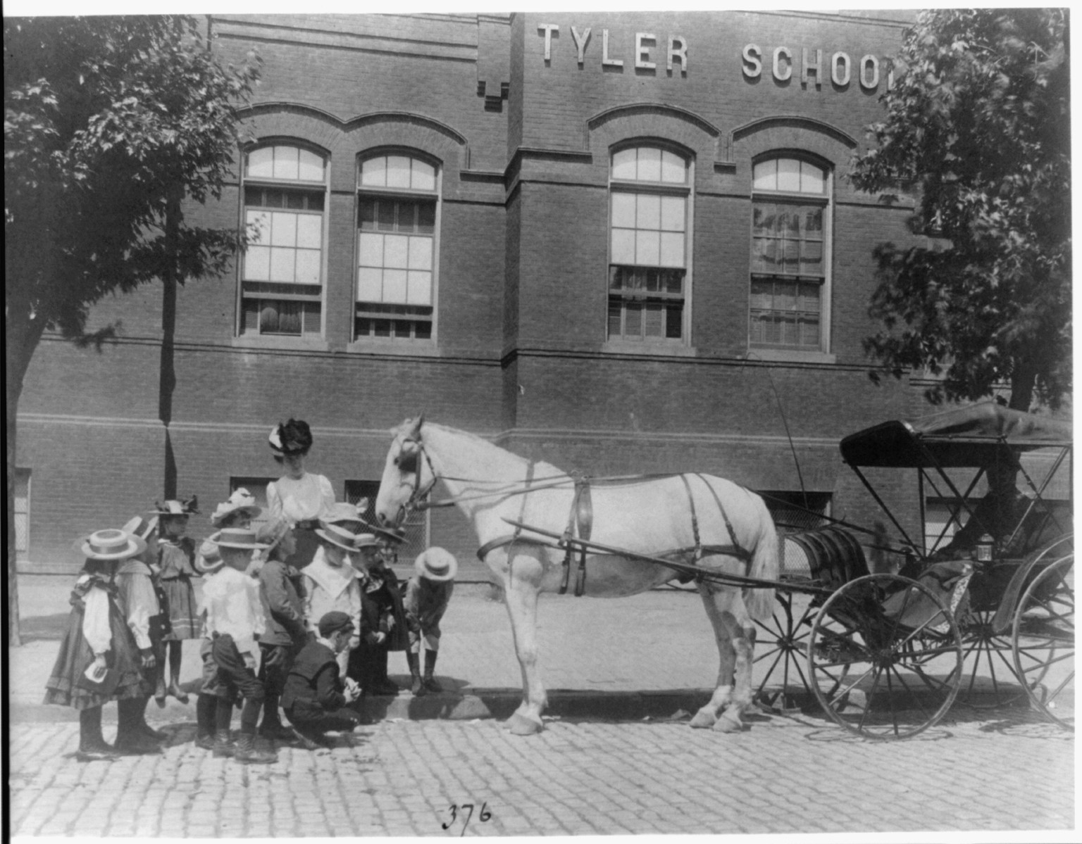 [Children studying a horse and buggy outside the Tyler School, Washington, D.C.], [1899?] — historic photograph
