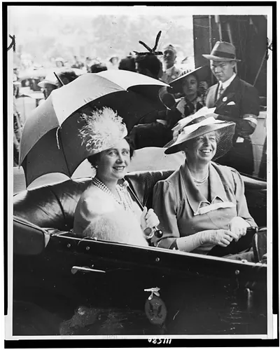 [Mrs. Eleanor Roosevelt and Queen Elizabeth, holding umbrella, in automobile, leaving station for the White House]