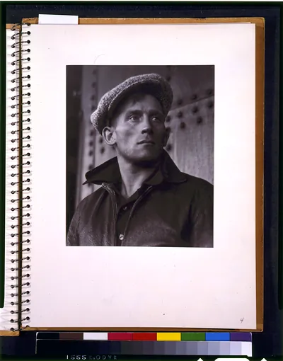 [Young man wearing cap]