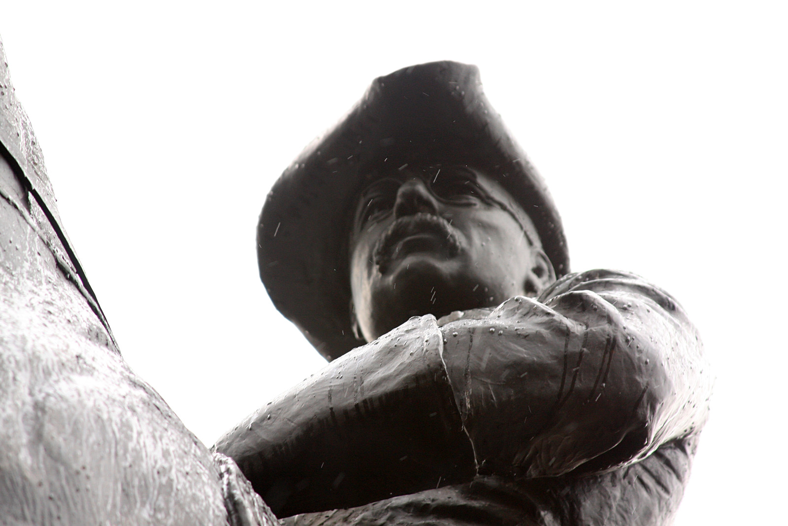 Bronze statue of a man in a tricorn hat, low angle — historic image