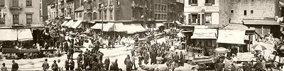 Crowded street market with pushcarts and awnings, sepia panorama