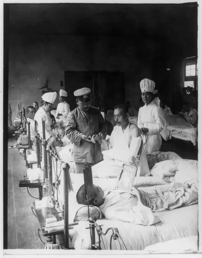 [Nurses and a doctor attending wounded soldiers on a hospital ward]