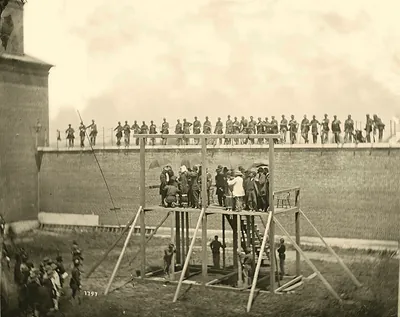 Gallows scene in walled yard with soldiers watching