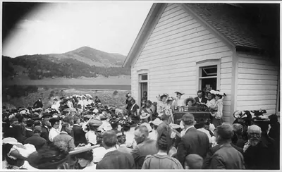 [Theodore Roosevelt seated outside church - choir singing There is Sunshine on the Soul." Rifle Colo.]"