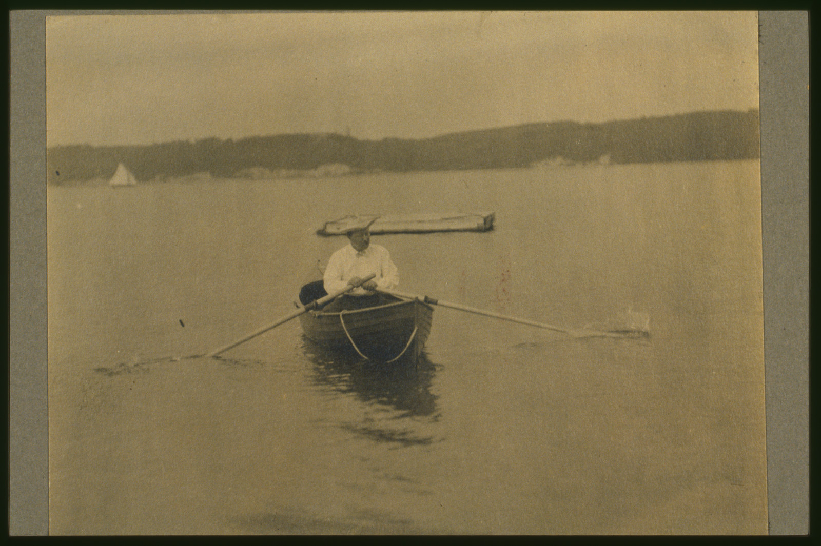 [Theodore Roosevelt, seated in rowboat, rowing], c1905. — historic photograph