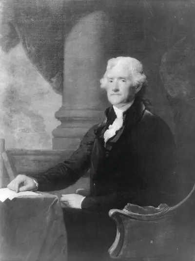 [Thomas Jefferson, three-quarter length portrait, seated at table, facing left]