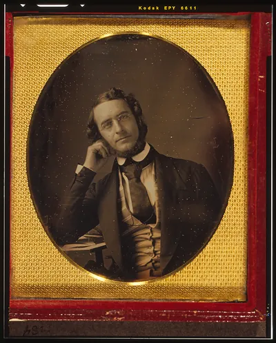 [James Curtis Booth, half-length portrait, seated with arm resting on table]
