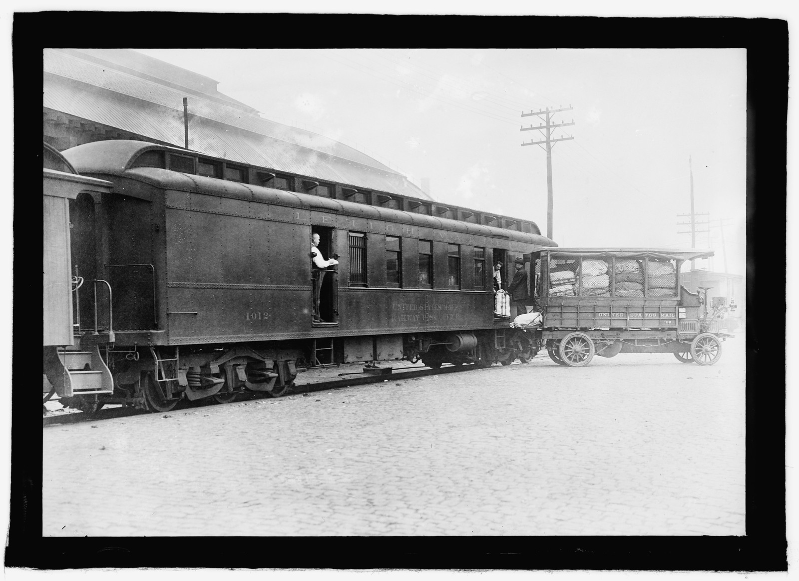 U.S. Mail, railroad car & mail truck, [between 1909 and 1940] — historic photograph