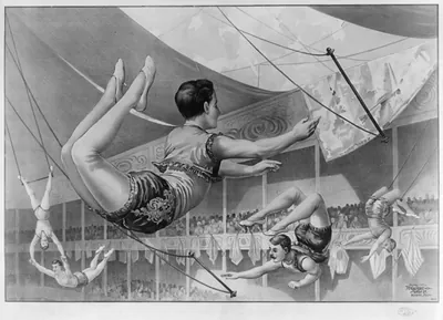 [Five male trapeze artists performing at a circus]