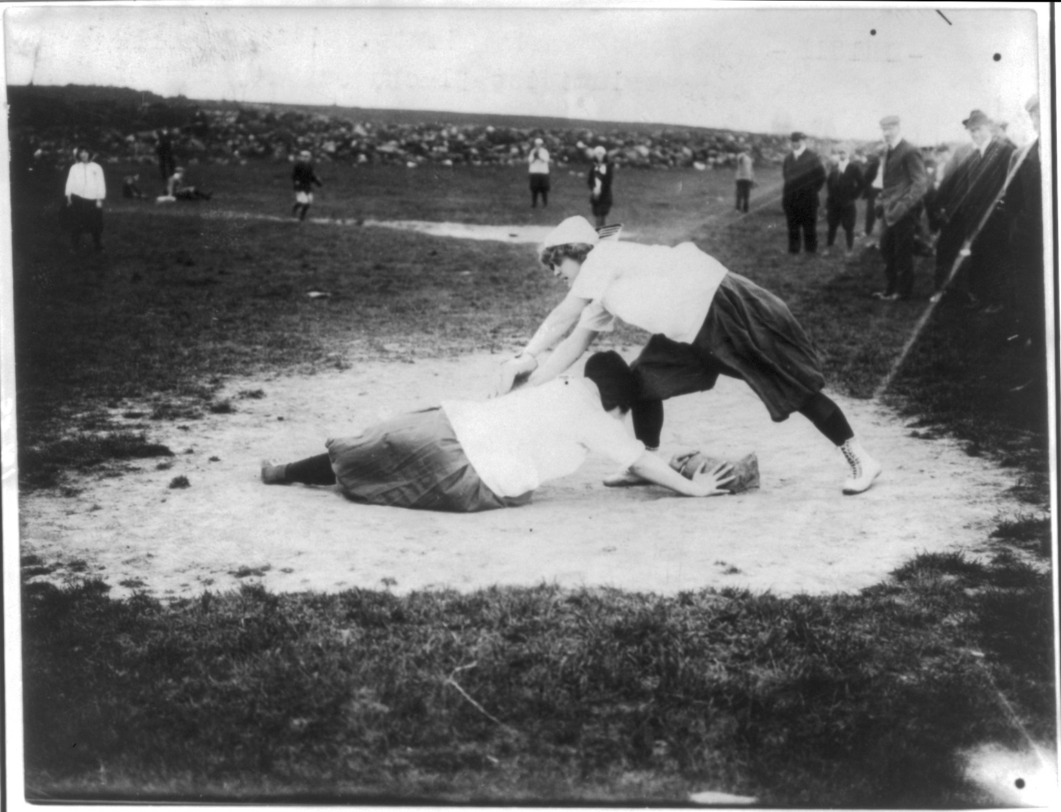 Baseball - New York Female Giants": Miss Schnall and Miss Slachu with hands on home plate", c1913 July 111. — historic image