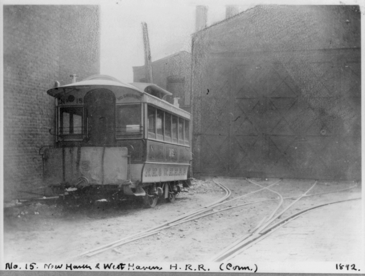 [Conn. - New Haven - horse-drawn street railways; N.H. & W.H.H.R.R. Co. cars in car barn yard: car no. 15] — historic photograph