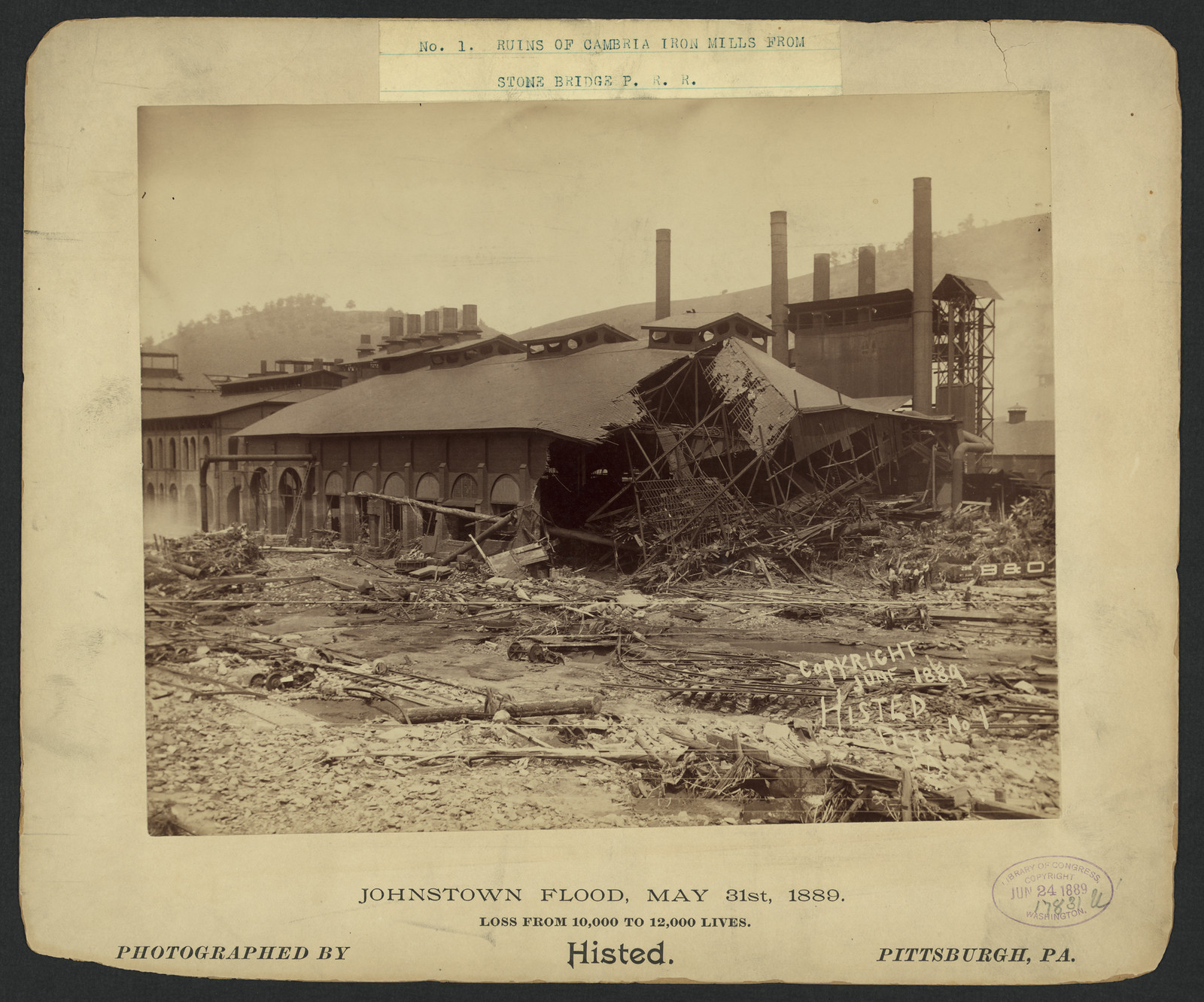 Ruins of Cambria Iron Mills from stone bridge P.R.R., Johnstown Flood, May 31st, 1889, c1889. — historic photograph
