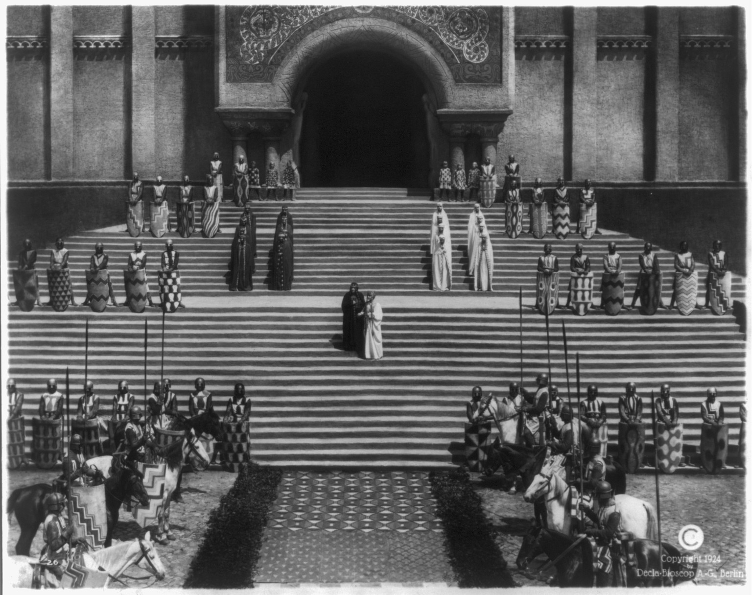 [Two queens await Brunhild on cathedral steps] — historic photograph