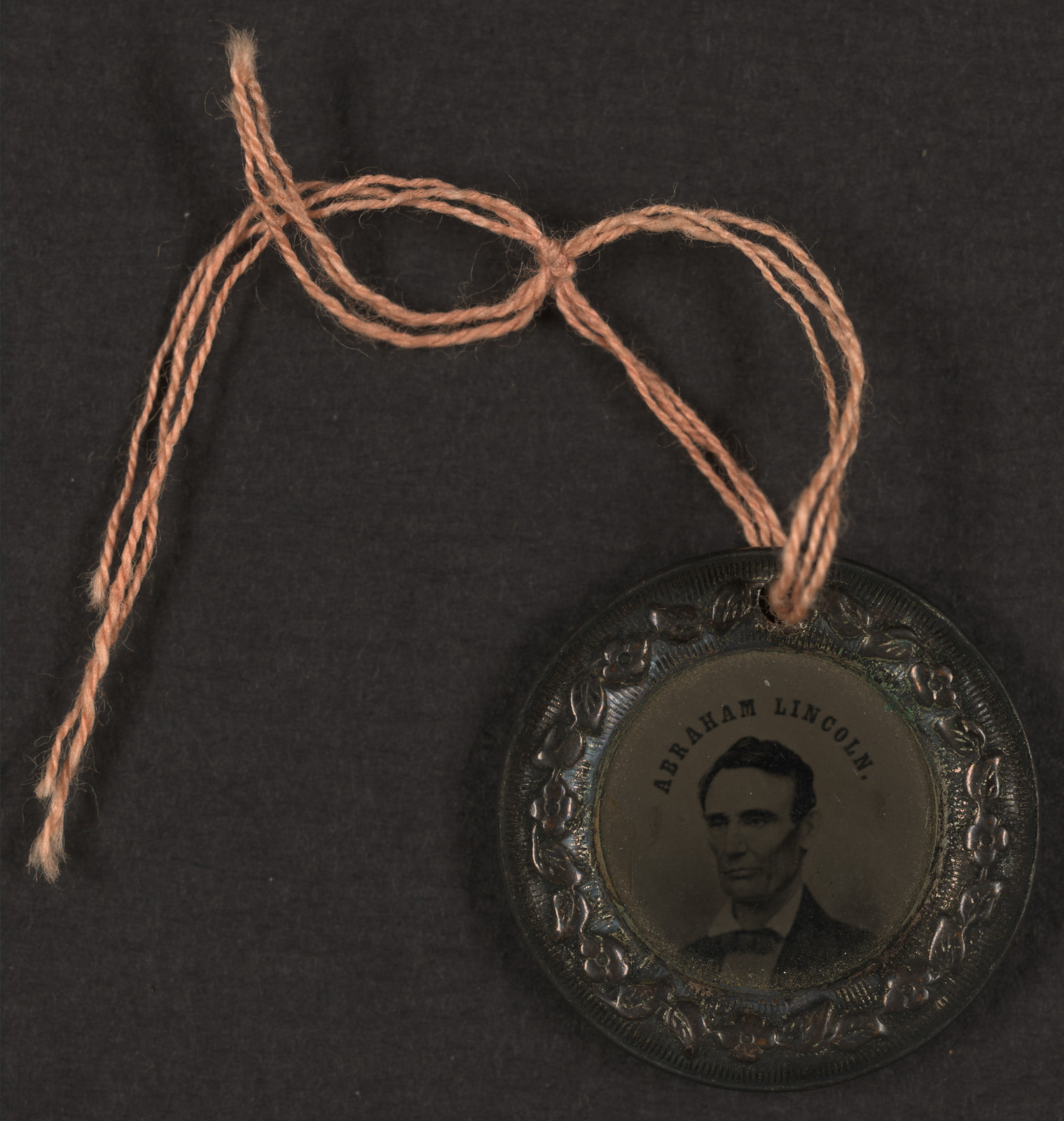Abraham Lincoln tintype portrait medallion tied with string — historic image