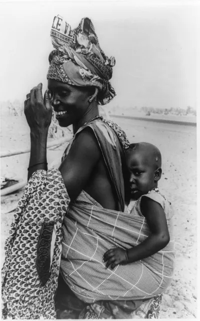 [Woman carrying baby on her back in the Sahelian Zone of West Africa during drought]