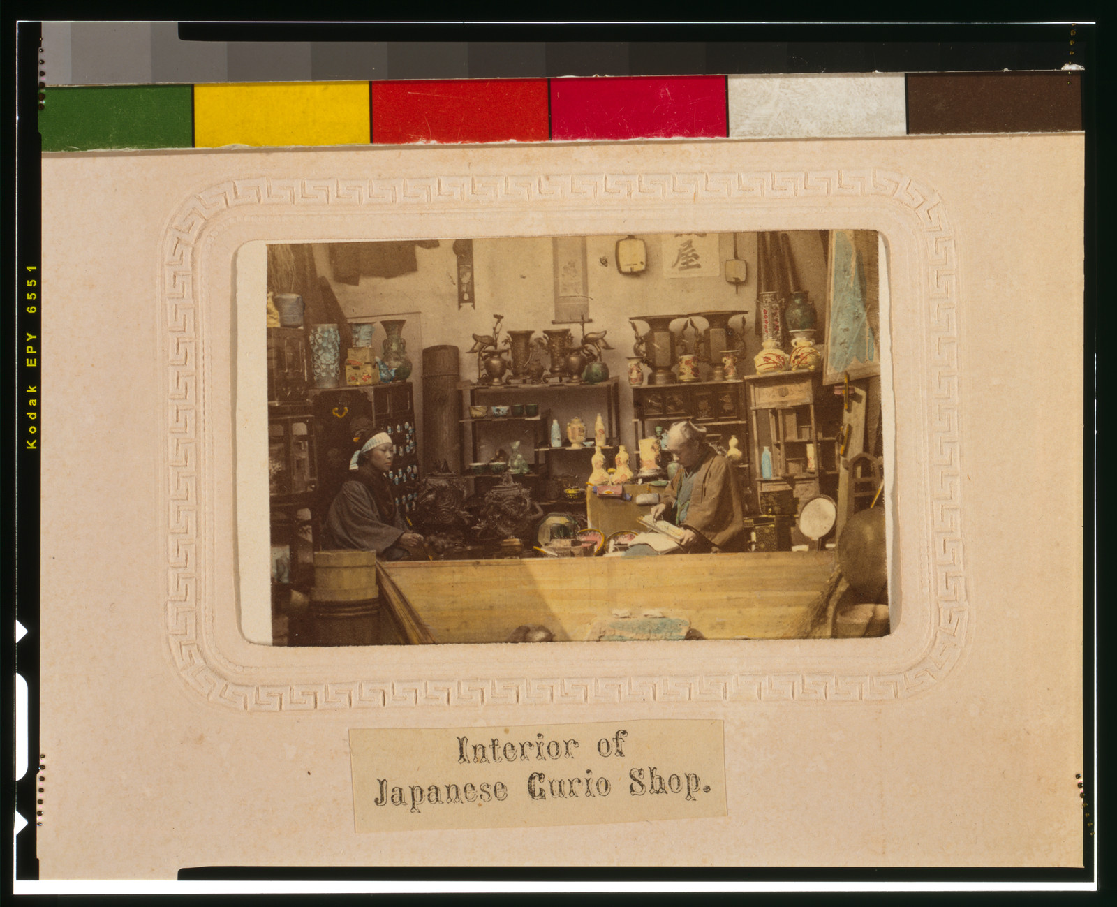 Interior of Japanese curio shop with two men — historic print