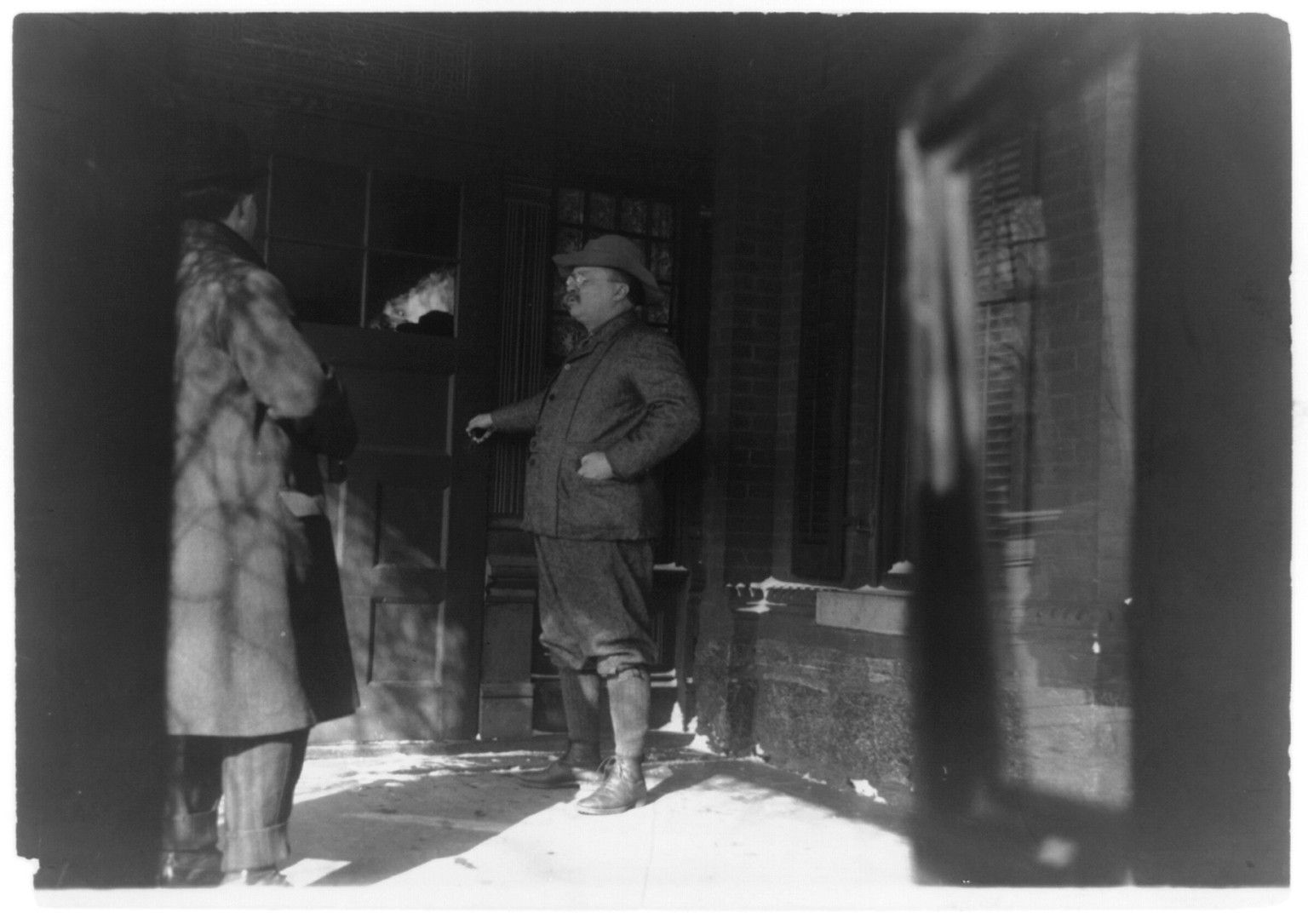 [Theodore Roosevelt, full-length, standing, facing left, opening door], c1909. — historic photograph