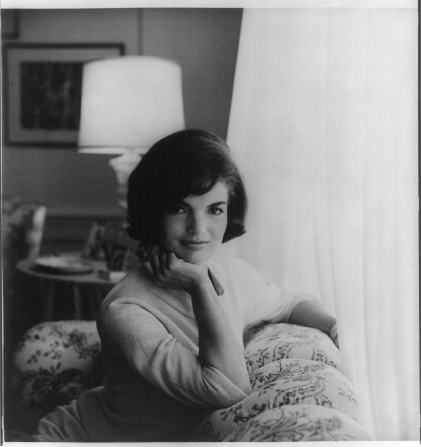 [First official White House photograph of Mrs. John F. Kennedy, half-length portrait, seated on couch, facing front], [1961] — historic photograph