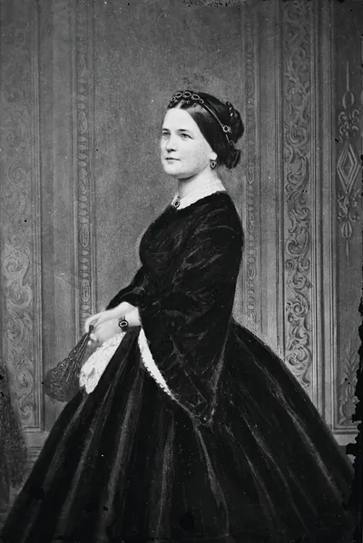 Woman in black velvet dress with jeweled hair ornament