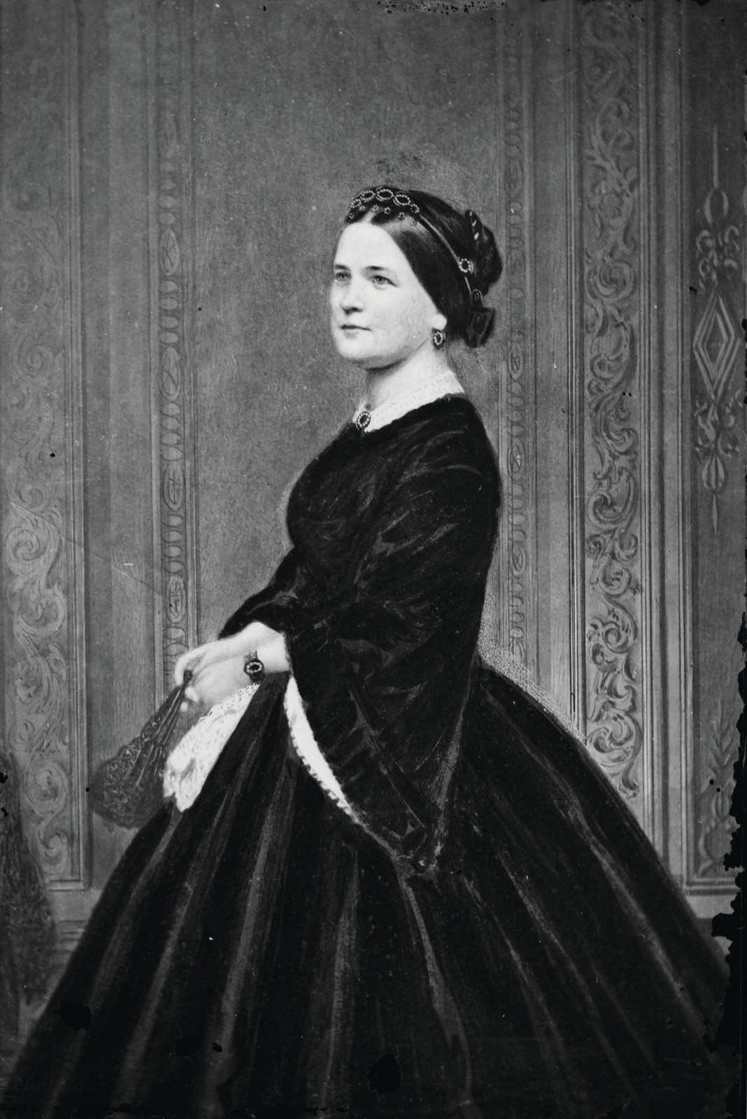 Woman in black velvet dress with jeweled hair ornament — historic image