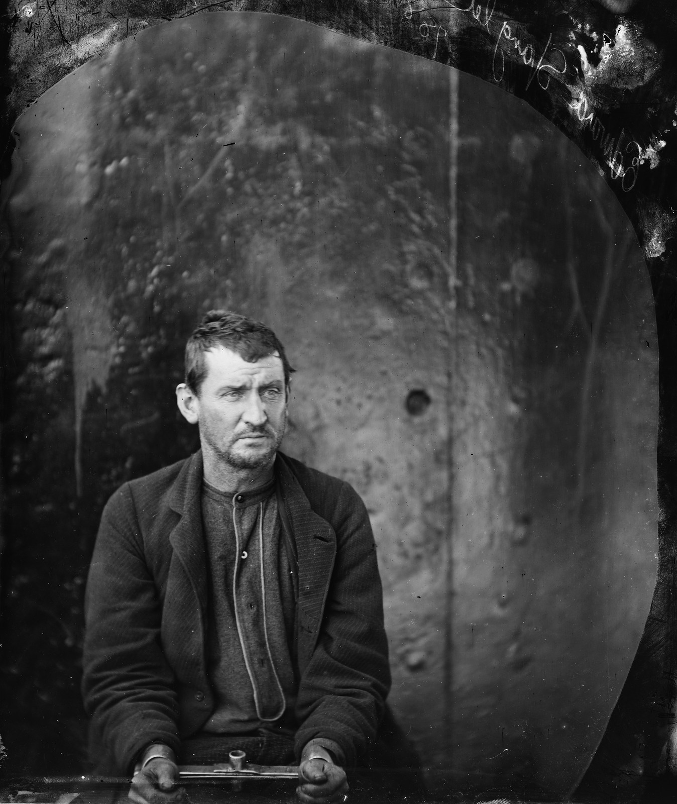 Seated man in handcuffs, 19th-century photographic plate portrait — historic photograph