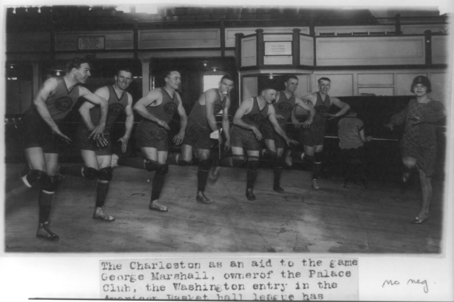 [Miss Vivian Marinelli giving lesson in dancing the Charleston to basketball players of Washington, D.C.'s Palace Club: Jones, Conway, Grody, Saunders, Kearns, Glascoe, and Manager Kennedy], 1926 Feb. 15. — historic photograph