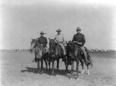 [Theodore Roosevelt, Frank P. Hayes(?) and another Rough Rider, all on horseback]