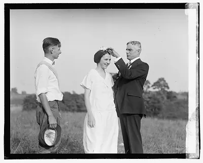 [Unidentified men and woman in field]