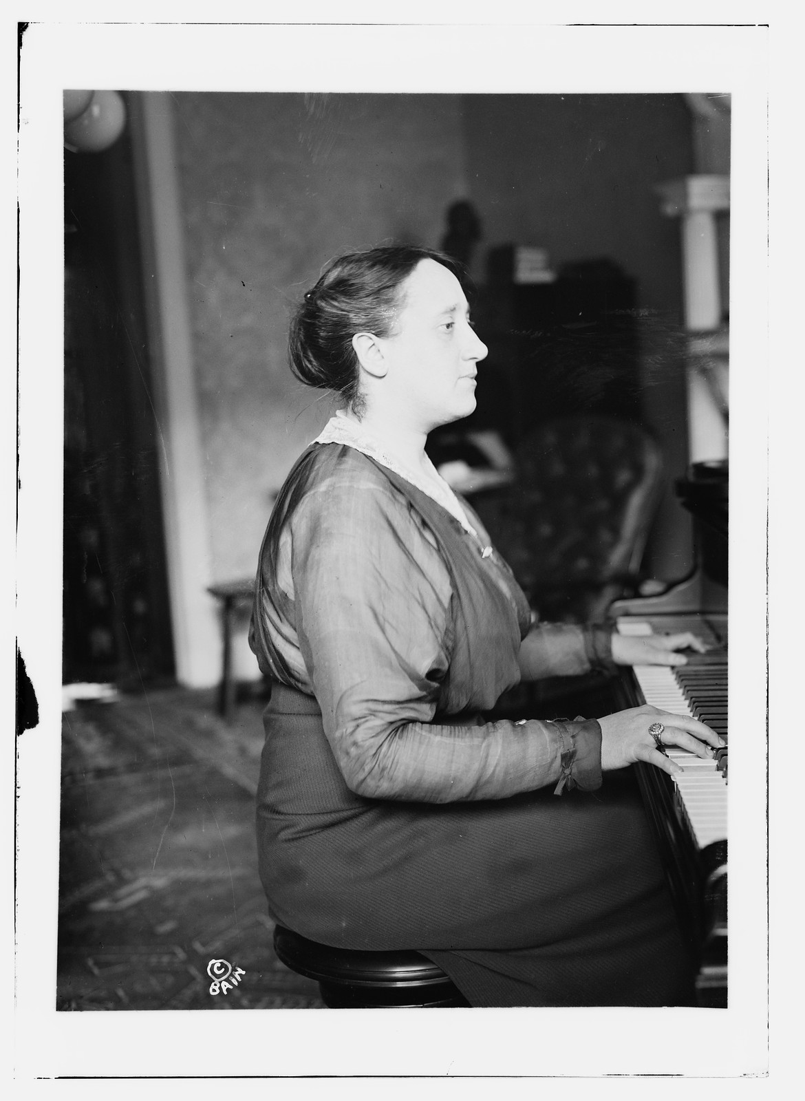 Melanie Kurt, at piano, n/a — historic photograph