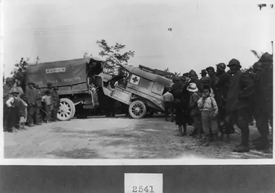 [A wrecked American Red Cross ambulance being towed by a truck, Italian Front]