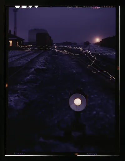 Railroad departure yard at dusk with light trails