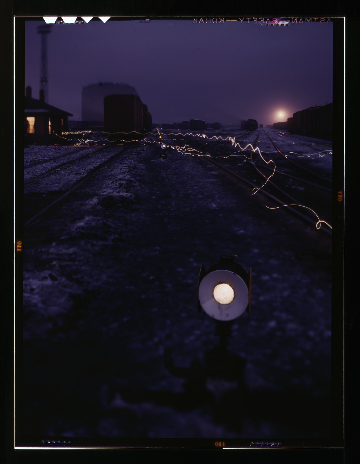 Railroad departure yard at dusk with light trails — historic image