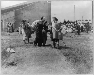 Two Japanese evacuee families meeting at assembly center, Salinas rodeo grounds