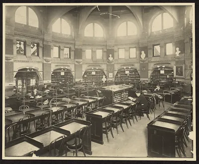 Library reading room with arched windows and wooden desks