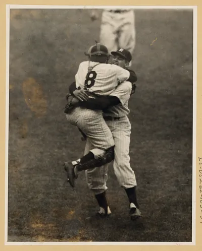 Two Yankees players in pinstripes embracing on the field, photograph